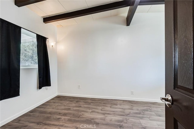 unfurnished room featuring wood-type flooring and lofted ceiling with beams