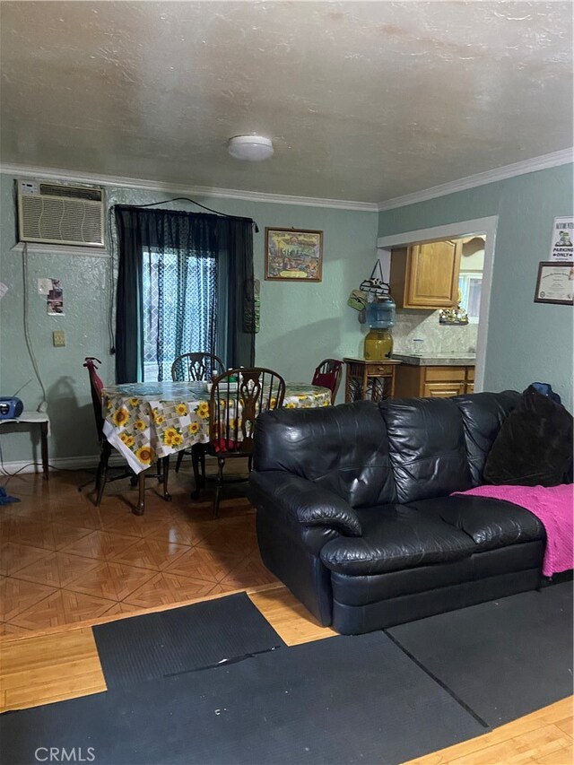 living room featuring an AC wall unit, parquet flooring, and crown molding