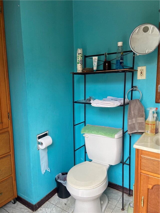 bathroom featuring tile patterned flooring, vanity, and toilet