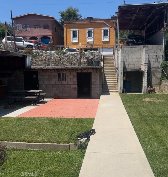 exterior space with a lawn and a patio area