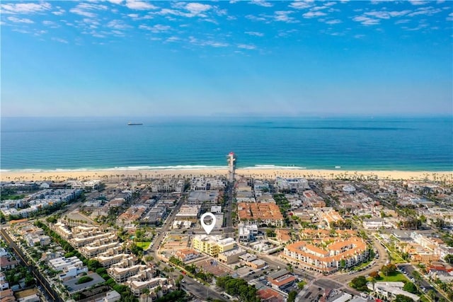 bird's eye view with a water view and a beach view