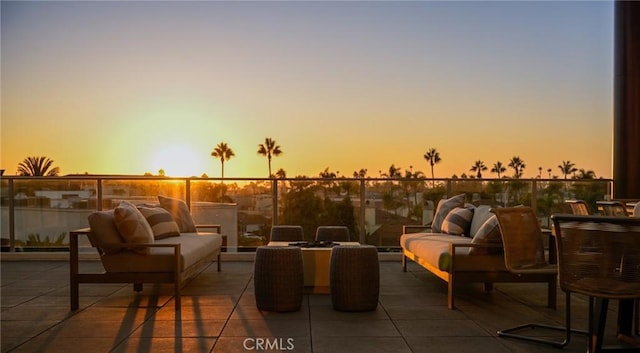 patio terrace at dusk featuring an outdoor hangout area