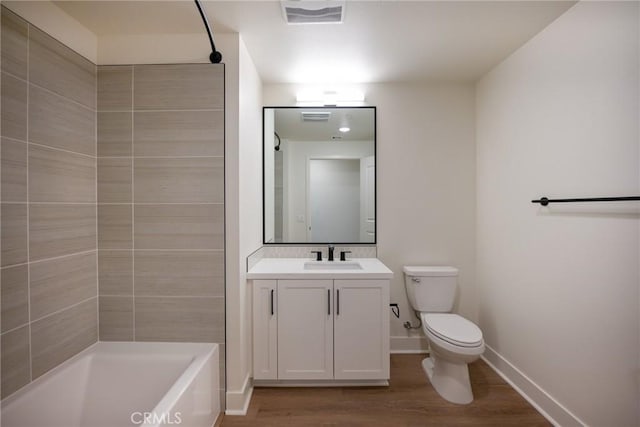 full bathroom featuring toilet, wood-type flooring, vanity, and separate shower and tub