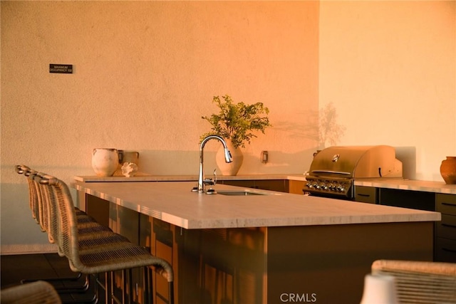 interior space featuring a breakfast bar and sink