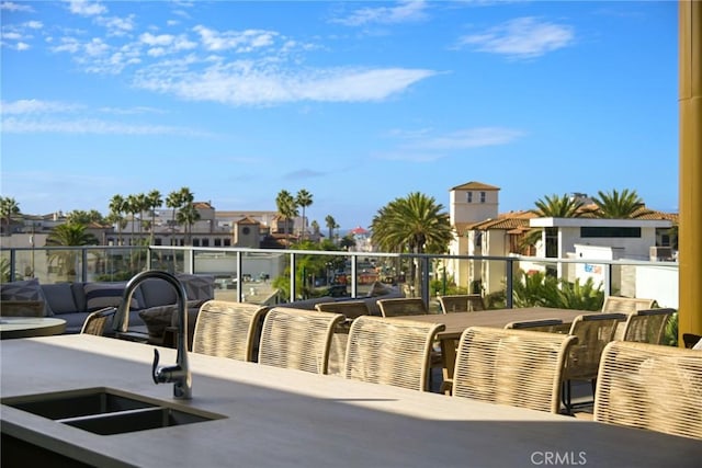 view of patio with a balcony and sink