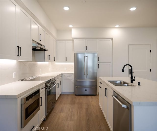 kitchen with white cabinetry, sink, light hardwood / wood-style floors, and appliances with stainless steel finishes