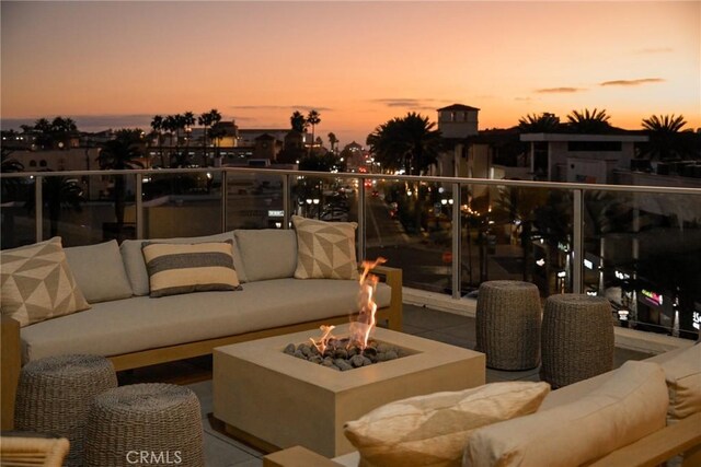 patio terrace at dusk featuring an outdoor hangout area