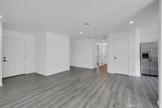 unfurnished living room with recessed lighting, visible vents, and wood finished floors