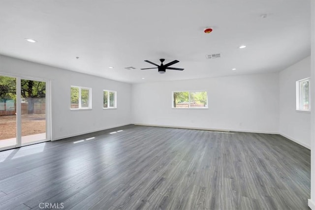 spare room featuring dark wood-style floors, recessed lighting, visible vents, ceiling fan, and baseboards