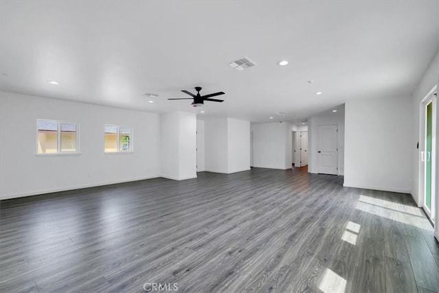 unfurnished living room with recessed lighting, dark wood-style flooring, a ceiling fan, baseboards, and visible vents