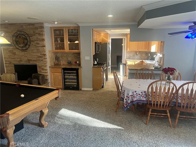 carpeted dining space featuring ceiling fan, sink, wine cooler, ornamental molding, and pool table