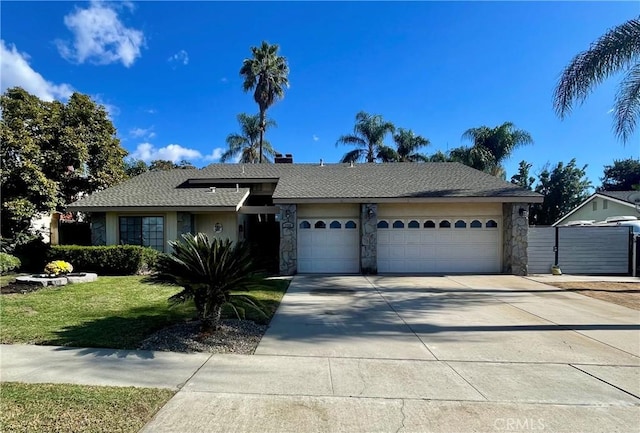 ranch-style home with a front yard and a garage