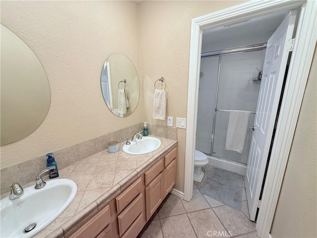1732 Winston Ave, Upland, CA 91784 - bathroom with a shower stall, double vanity, tile patterned floors, and toilet