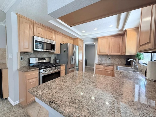 1732 Winston Ave, Upland, CA 91784 - kitchen with appliances with stainless steel finishes, a sink, light brown cabinetry, a tray ceiling, and a peninsula