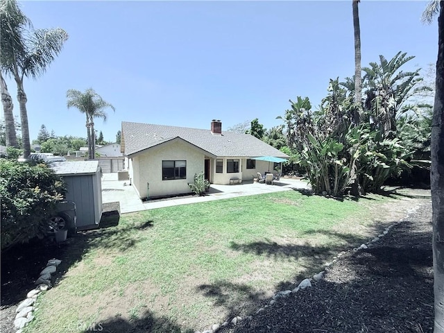 1732 Winston Ave, Upland, CA 91784 - back of house featuring a patio, stucco siding, a storage unit, a yard, and an outdoor structure