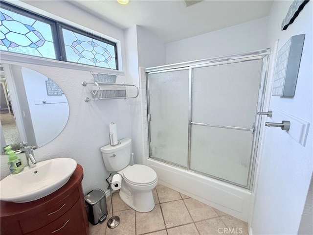 1732 Winston Ave, Upland, CA 91784 - bathroom featuring toilet, tile patterned floors, vanity, and bath / shower combo with glass door