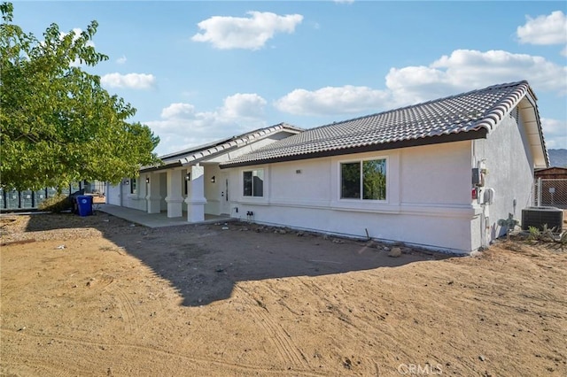 back of house featuring central air condition unit and a patio area