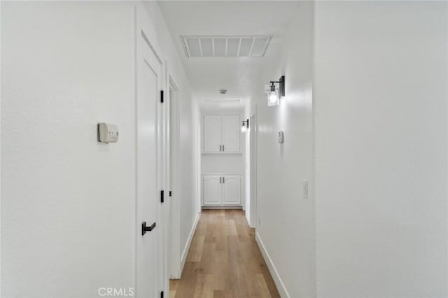 corridor with light hardwood / wood-style floors