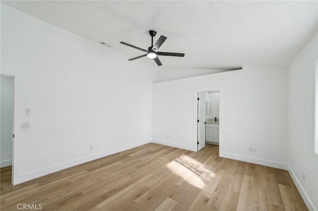 empty room with light wood-type flooring, vaulted ceiling, and ceiling fan