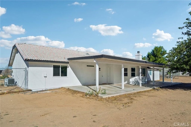 back of property with a patio area and cooling unit