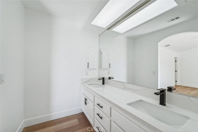 bathroom with hardwood / wood-style floors and vanity