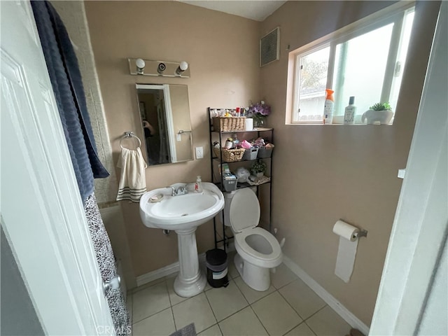 bathroom with tile patterned flooring and toilet