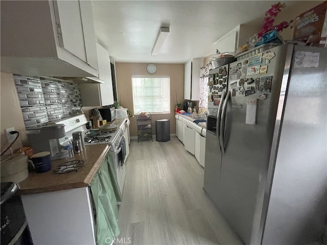 kitchen featuring decorative backsplash, light hardwood / wood-style floors, white cabinetry, and stainless steel appliances