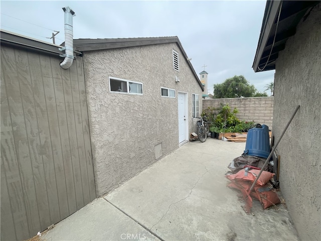 view of side of property with a patio area