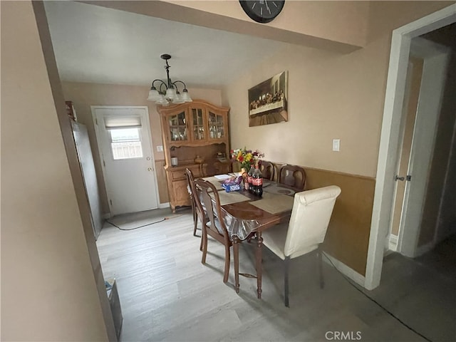 dining room with a notable chandelier and light hardwood / wood-style flooring