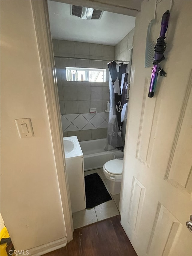 full bathroom with wood-type flooring, shower / bath combo, toilet, and vanity