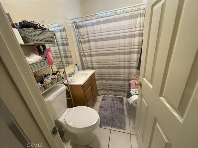 bathroom with walk in shower, tile patterned flooring, vanity, and toilet