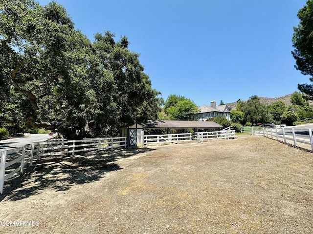 view of yard with a rural view