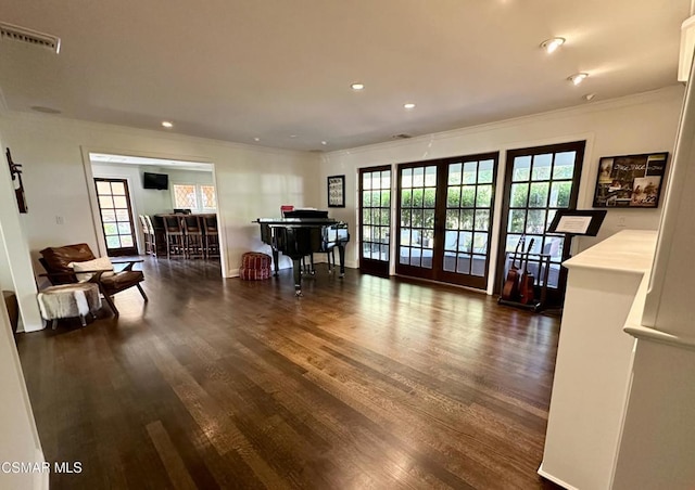 living room featuring dark wood-type flooring, crown molding, and french doors