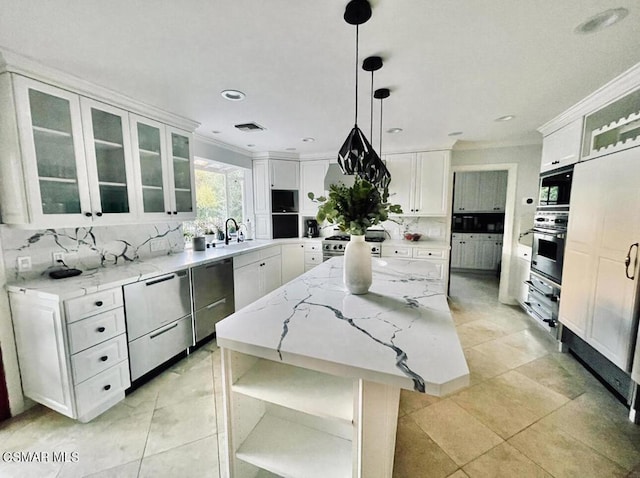 kitchen featuring white cabinetry, appliances with stainless steel finishes, tasteful backsplash, a kitchen island, and pendant lighting