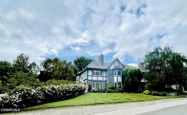 tudor house with a front yard