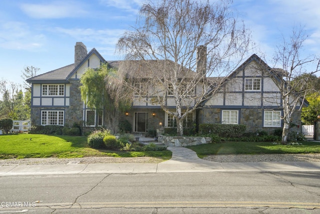 english style home with a front yard