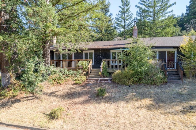 single story home with a wooden deck