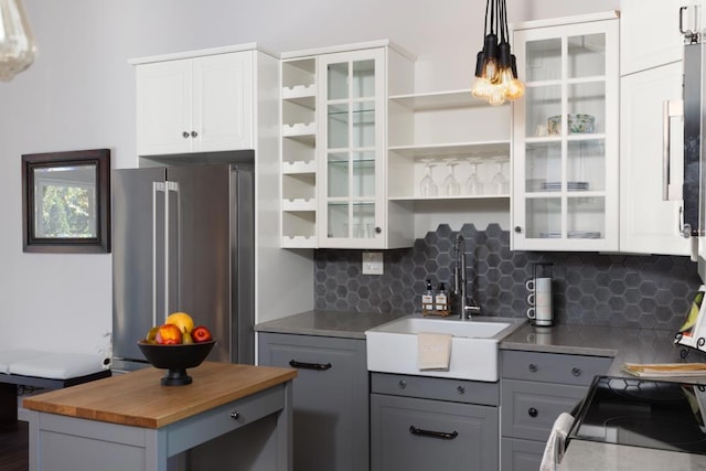 kitchen with gray cabinetry, wood counters, tasteful backsplash, high end fridge, and white cabinetry