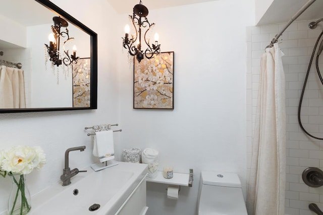 bathroom with a chandelier, toilet, walk in shower, and sink