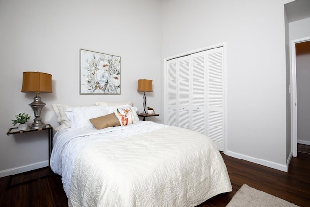 bedroom with a closet and dark wood-type flooring