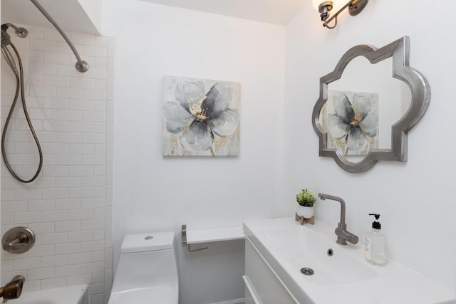 full bathroom featuring toilet, vanity, and tiled shower / bath combo