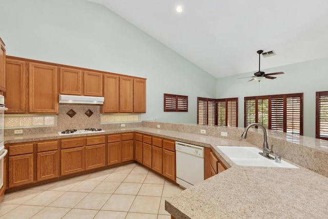 kitchen with ceiling fan, sink, high vaulted ceiling, kitchen peninsula, and white appliances