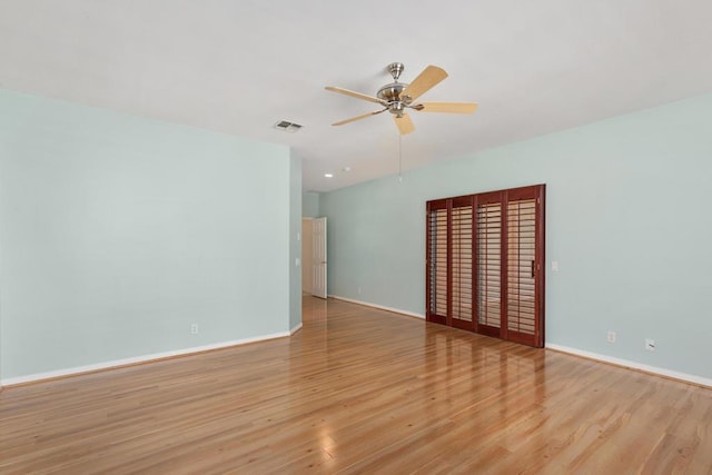 empty room featuring light hardwood / wood-style flooring and ceiling fan