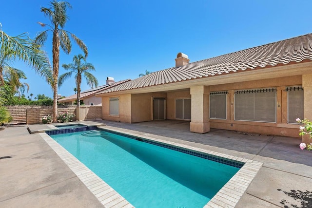 view of swimming pool with a patio area and an in ground hot tub