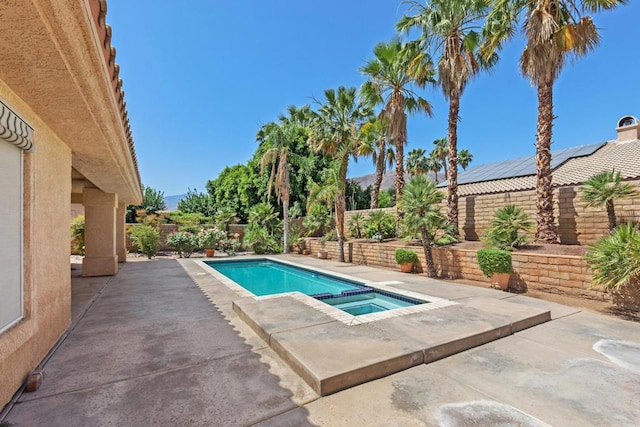 view of swimming pool featuring an in ground hot tub and a patio