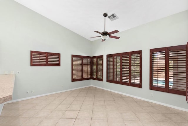 spare room featuring ceiling fan, light tile patterned flooring, and high vaulted ceiling