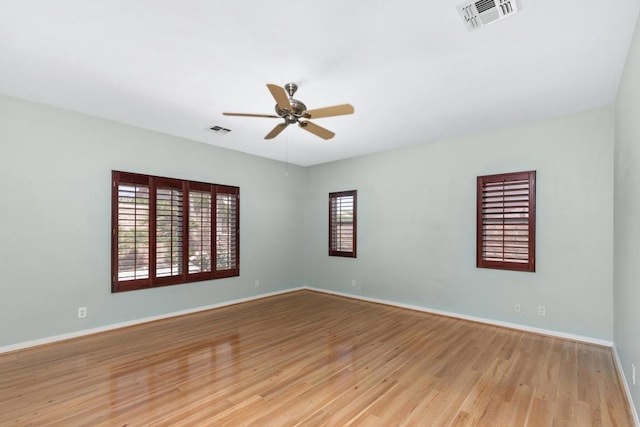 spare room featuring light hardwood / wood-style floors and ceiling fan