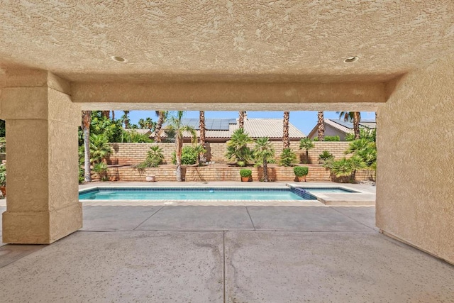 view of swimming pool featuring an in ground hot tub