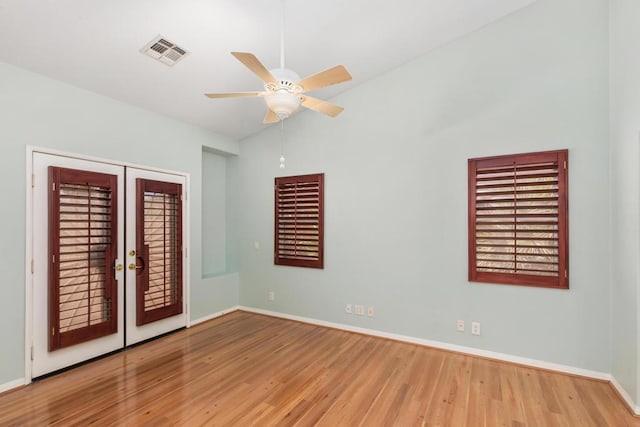 unfurnished room with french doors, light hardwood / wood-style floors, vaulted ceiling, and ceiling fan