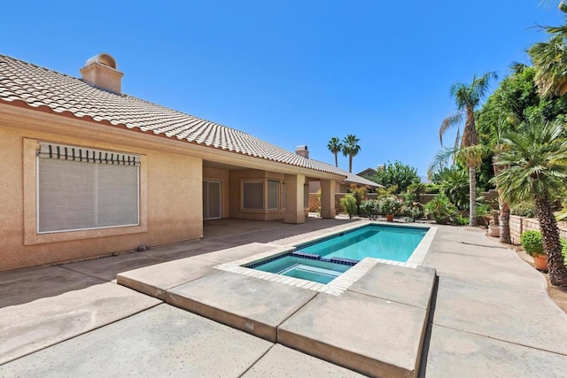 view of pool featuring an in ground hot tub and a patio